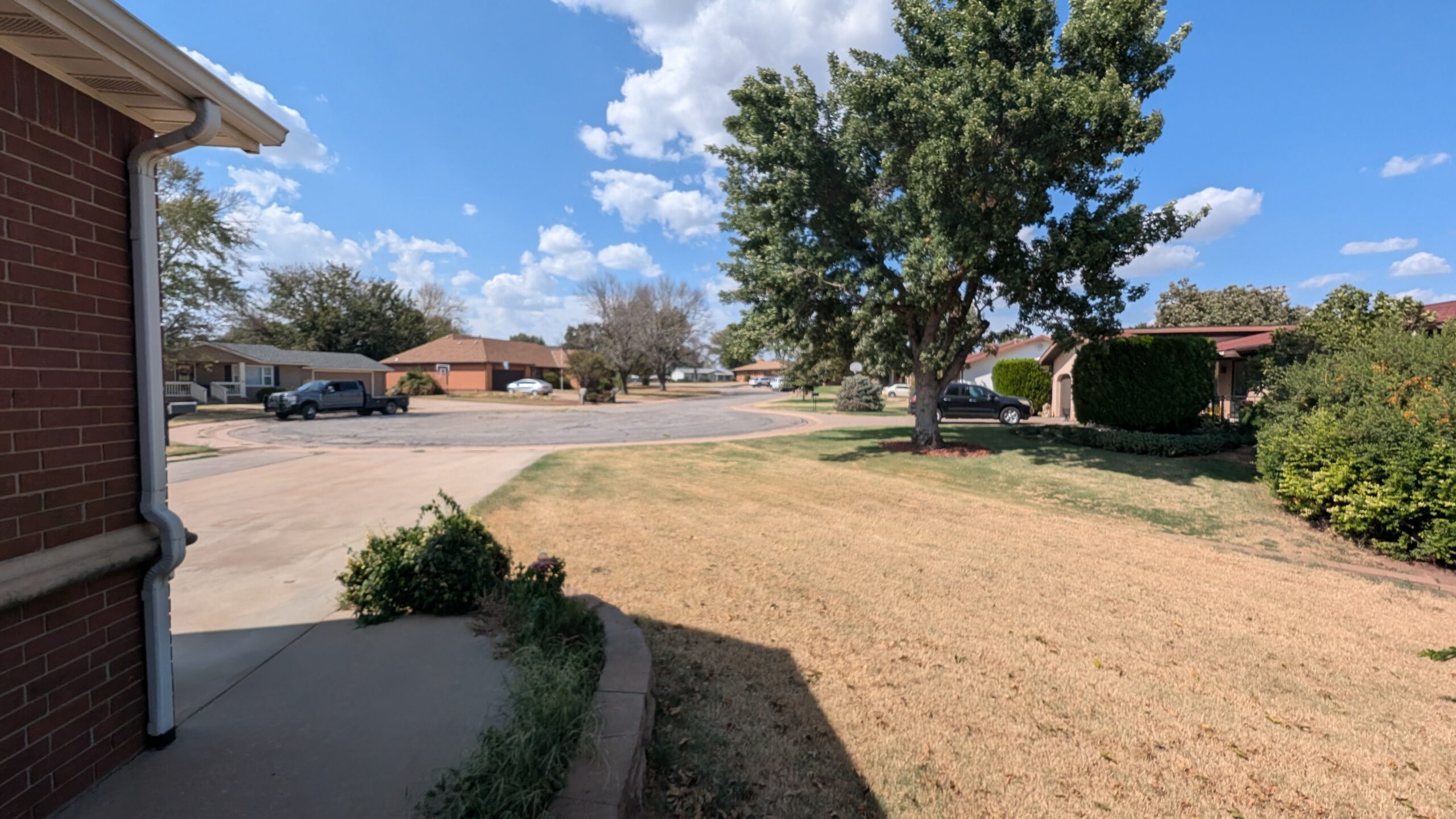 120 Lisa Circle in Medicine Lodge, Kansas — Brick exterior and side yard