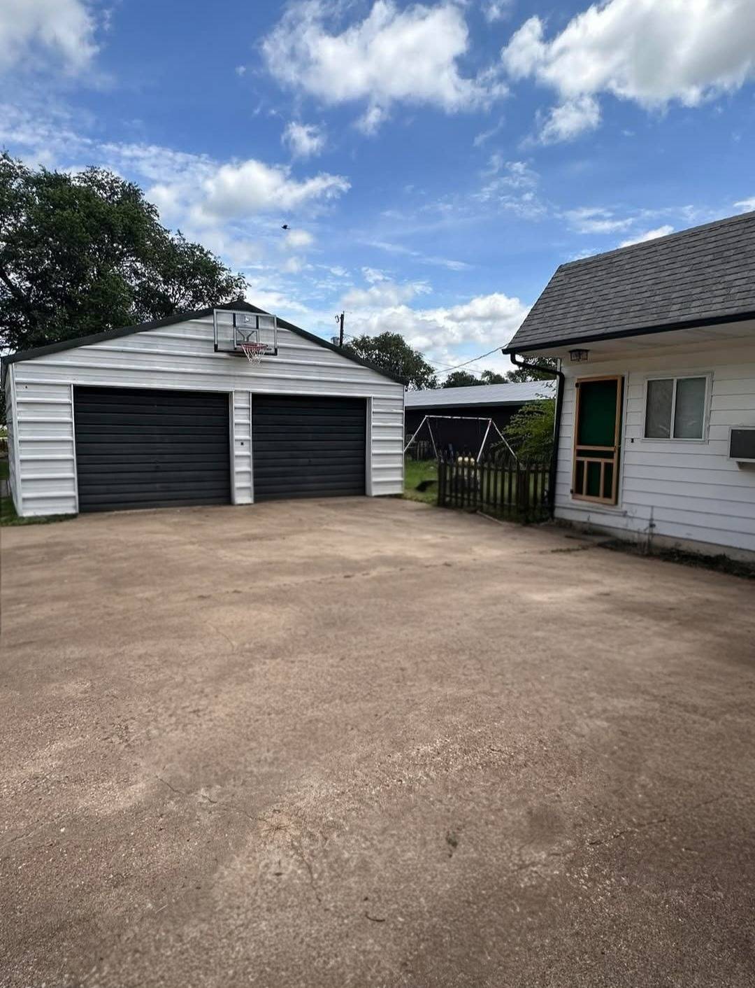 430 Campbell St. in Kiowa, Kansas — Detached garage and driveway